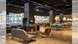 Gino's seating area with long sofas and green chairs.