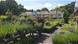Outside the garden centre, filled with plants and a large white cottage style building.