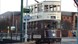 Brown and cream vintage tram being driven along the old original tramlines.