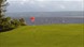 A red flag on a golf course overlooking the Wirral
