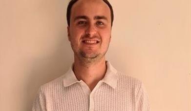 image of Harry Roche, a white man in his thirties posing against a plain background