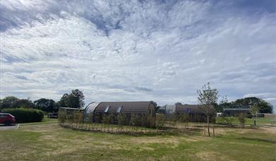 Some of the pods at Experience Freedom Glamping at Cayton Village with the surrounding countryside 