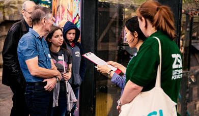 Deaf Led BSL Tour at London Zoo – Group of people watching a Deaf Presenter signing