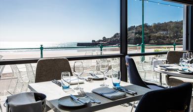 Tables set ready for dinners with views across the bay from Oyster Box
