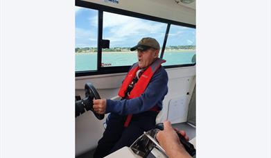 man steering at boat with Wetwheels Jersey