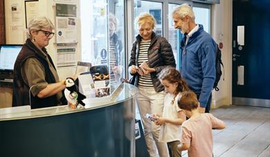 family buying tickets for Jersey Heritage Maritime Museum