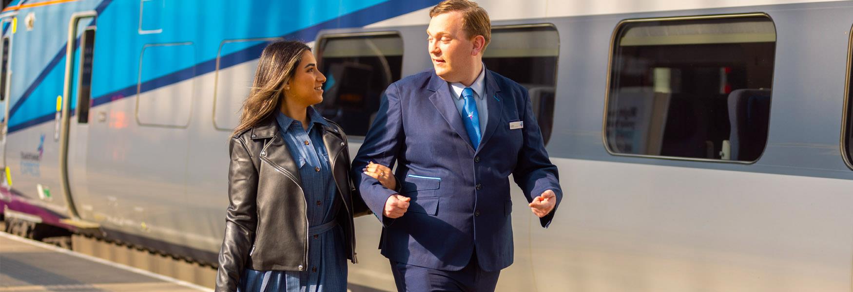 TransPenine staff helping a blind woman access the train