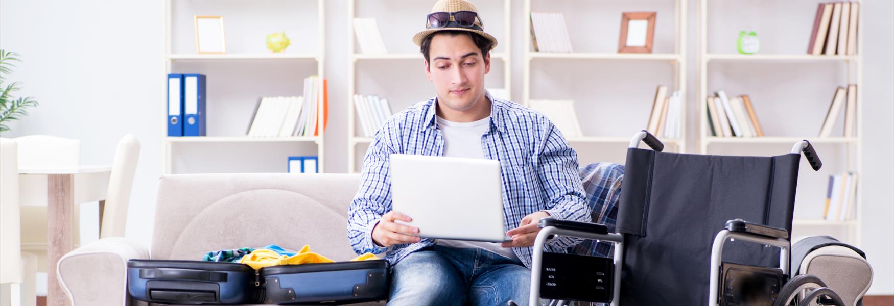 Man planning holiday with wheelchair in background