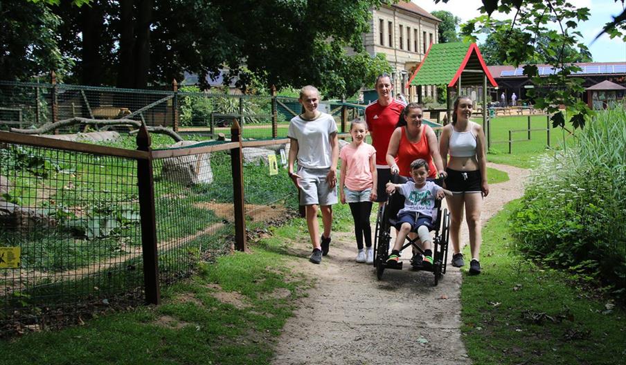 Family exploring Thrigby Hall Wildlife Gardens, with one child in a wheelchair