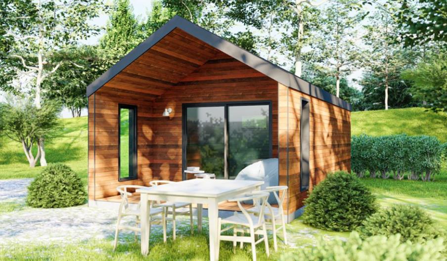 Glamping lodge at Coniston Park Coppice with dining table outside among the trees