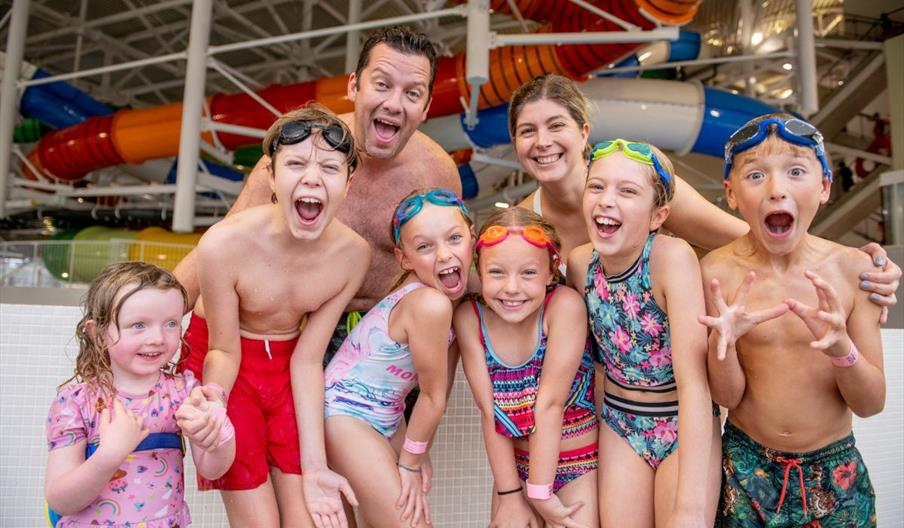 Aa group of children with two adults in swim wear at the Wave