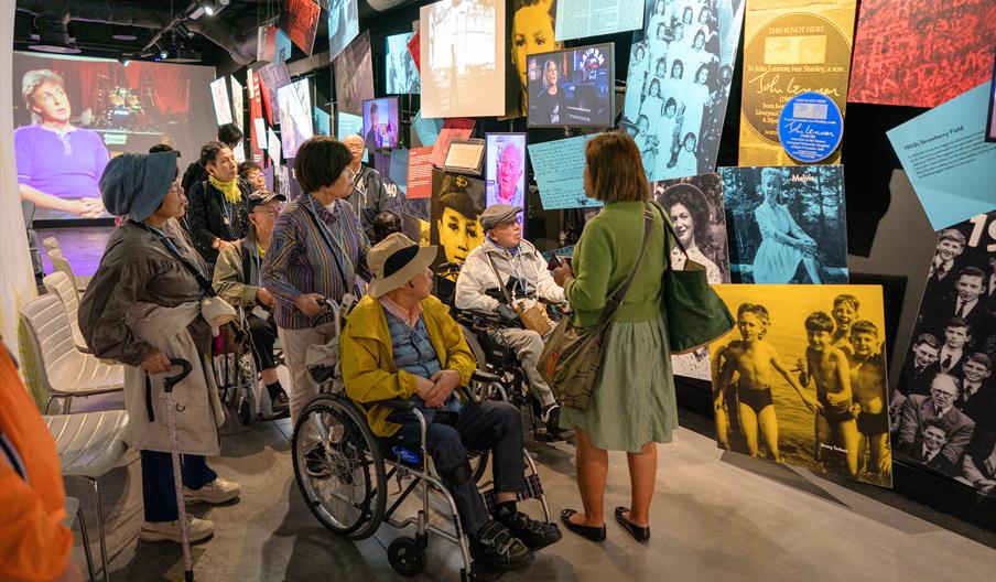 A group of visitors in the Strawberry Field exhibition