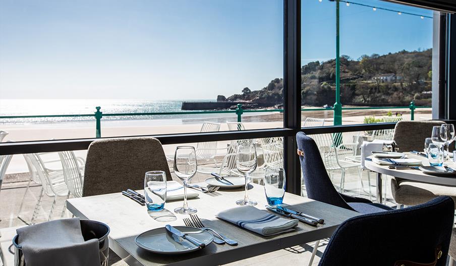 Tables set ready for dinners with views across the bay from Oyster Box