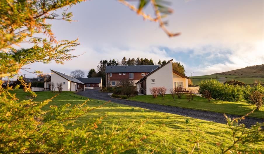 The outside of Elderburn Lodges. Image taken through trees