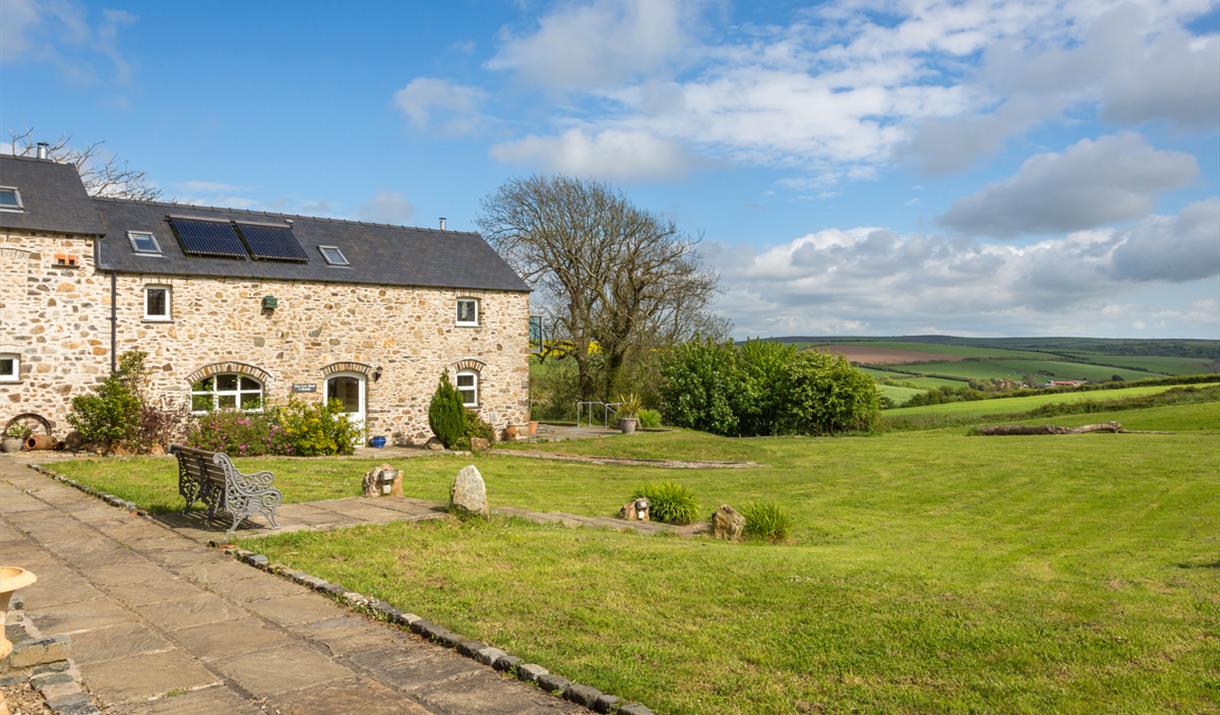 Grounds surrounding Asheston Eco Barns on a summer's day