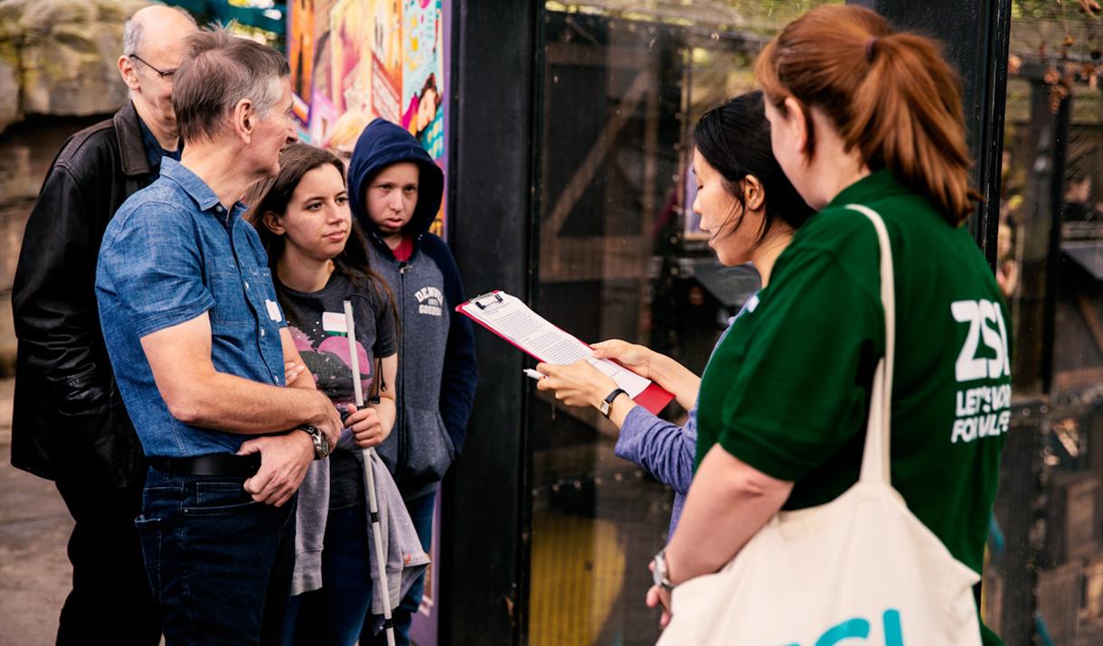 Deaf Led BSL Tour at London Zoo – Group of people watching a Deaf Presenter signing