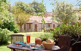 picnic laid out on table at keld head farm cottages with the cottages in the background