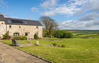 Grounds surrounding Asheston Eco Barns on a summer's day