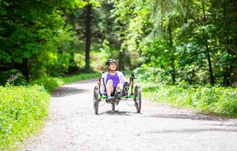 person riding accessible bike at Dalby Forest