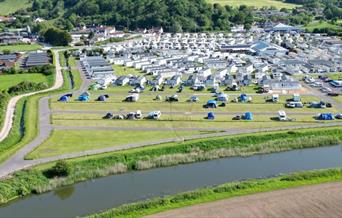 birdseye view of Riverside Holiday Village with all the caravans. The river is running through the park