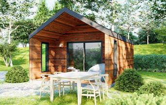 Glamping lodge at Coniston Park Coppice with dining table outside among the trees