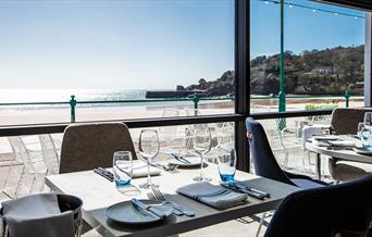 Tables set ready for dinners with views across the bay from Oyster Box