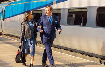 transpennine member of staff helping a blind passenger access the train