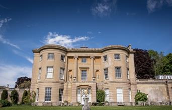 A large Bath stone building in beautiful gardens at American Museum and Gardens