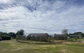 Some of the pods at Experience Freedom Glamping at Cayton Village with the surrounding countryside