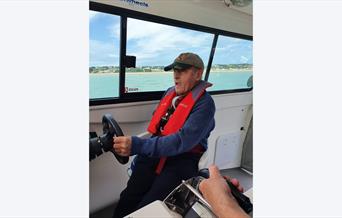 man steering at boat with Wetwheels Jersey