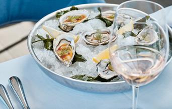 oysters served with wine at Sumas Restaurant