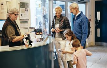 family buying tickets for Jersey Heritage Maritime Museum