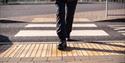 Person walking over a crossing at a train station