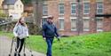 A lady using walking assistance at National Trust Quarry Bank