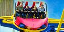 A photo of a family having fun on a Rollercoaster that twists and spins.