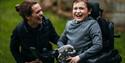 Child in wheelchair with keepers at Woburn Safari Park