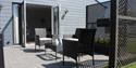 Table and chairs on the decking at Coastal Cottage