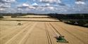Tractors mowing the fields around Sparham Hall Farm Holidays