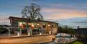 Hoe Grange Holiday's accessible lodges in the evening with the ramp lit up