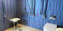 Accessible bathroom with shower seat at HEX Hotel at Yorkshire Wildlife Park