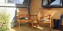 chairs on the decking outside the pods at Cayton Village