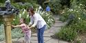 Parent and child using the water feature at Mount Stewart – National Trust ©National Trust Images/Naomi Goggin