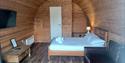 Lady Heyes Holiday park inside pod, showing a double bed and a seating area