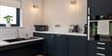 Dark blue kitchen with lowered sink