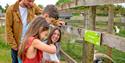 A family feeding geese at Fairytale Farm