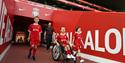 Three boys, one in a wheelchair going out onto the pitch LFC Stadium Tours & Experience