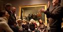 a group of people watching a BSL interpreter inside the national portrait gallery
