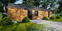 Side view of a lodge at Coniston Park Coppice with parking area