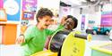 boy laughing and enjoying the interactive exhibits at Eureka!