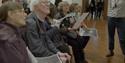 A group of people taking part in the audio described tour at National Portrait Gallery